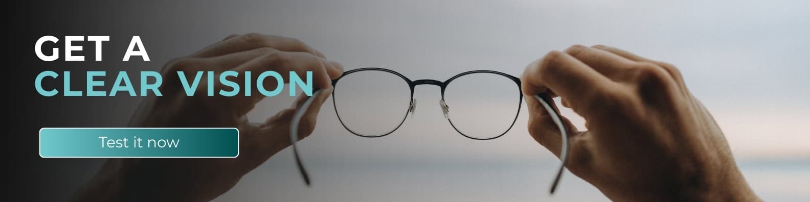 Wide website banner with the headline “Get a Clear Vision” and a “Test it now” call-to-action button, featuring hands holding eyeglasses against a blurred background to represent clarity, strategic focus, and data-driven business insights.